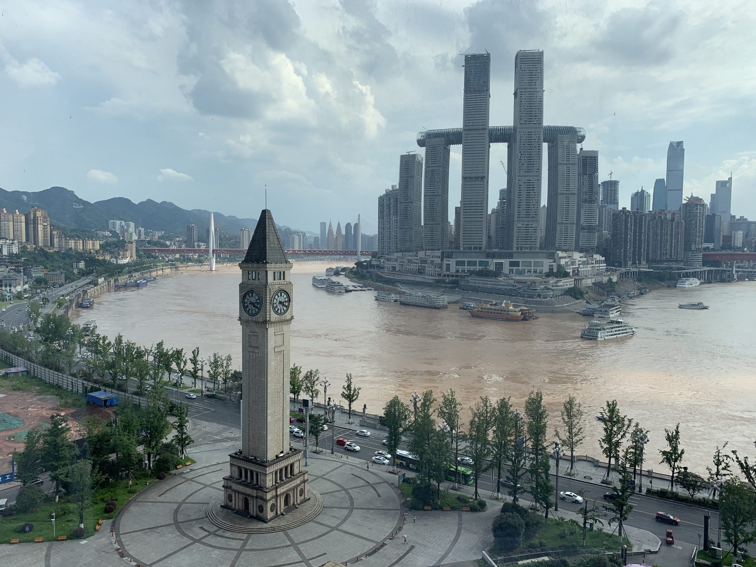 Clock tower of Chongqing in foreground with new skyscrapers under construction in the background