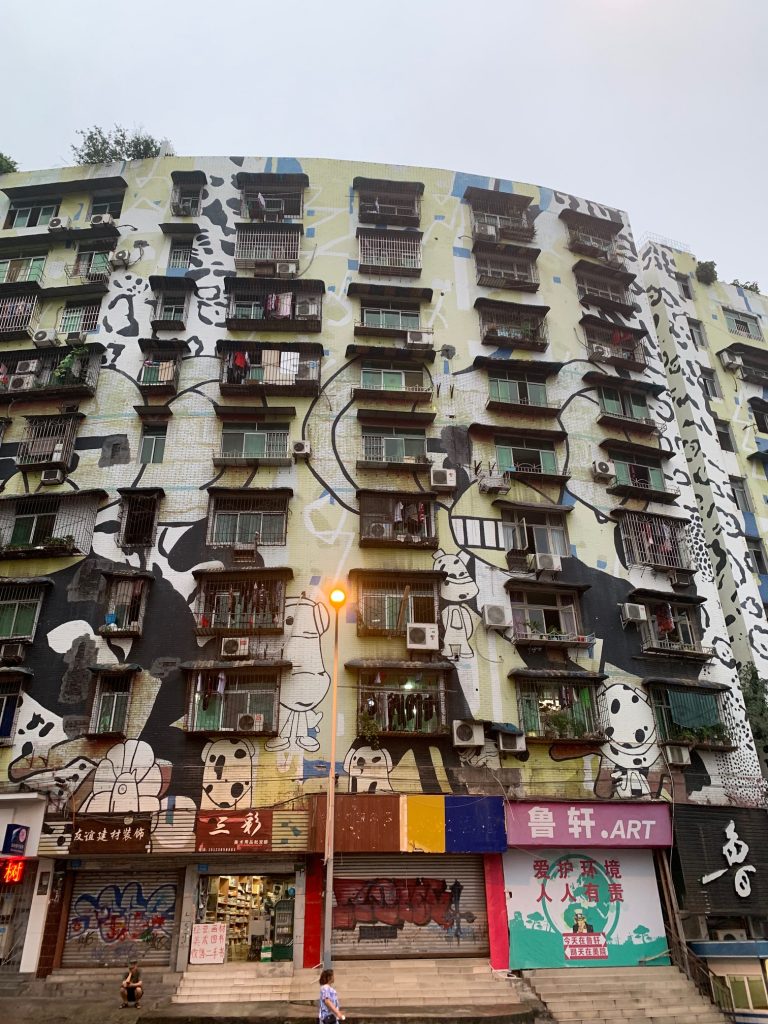 Apartment block and shops in Chongqing with panda graffiti